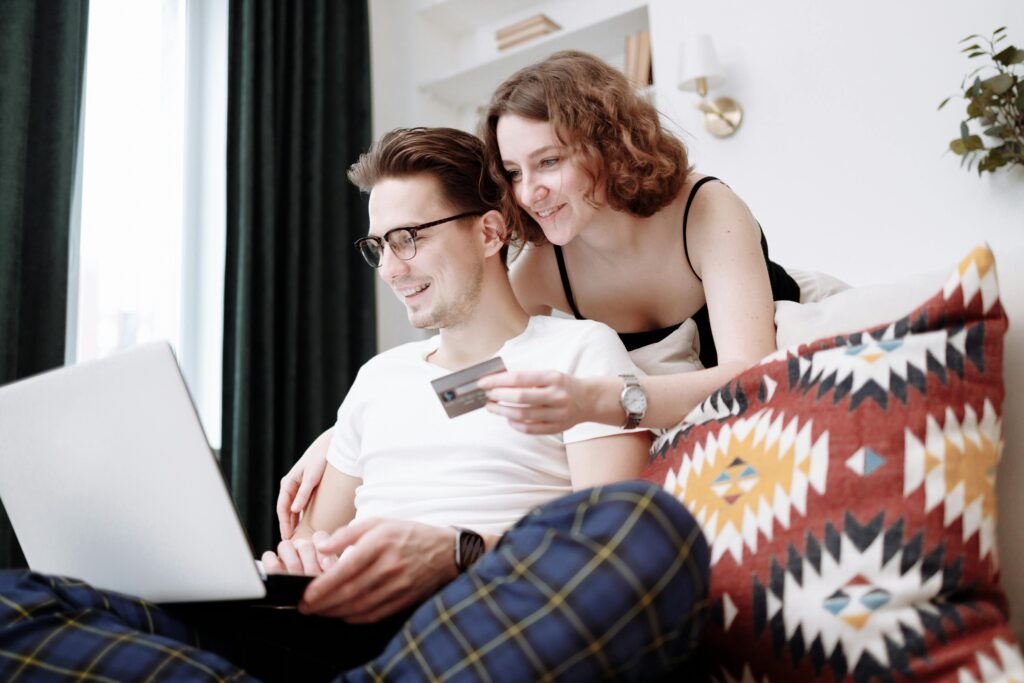 A couple shopping online using a laptop and credit card, representing trust, online buying behavior, e-commerce branding, and customer confidence in digital businesses.